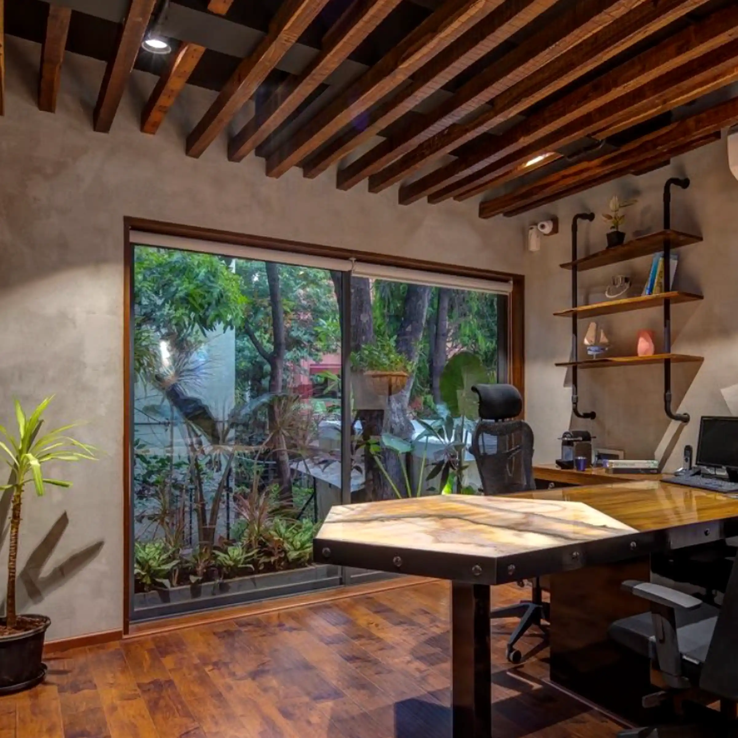Executive workspace with wood desk, concrete-style walls, and outdoor greenery